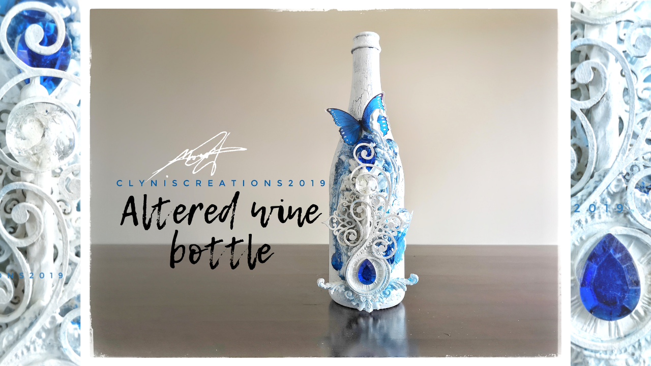 blue butterfly on a bottle, white bottle, blue bottle, Prima IOD Mould embellishment, wine bottle recycling, wine bottle upcycling, home decor, mixed media art tutorial